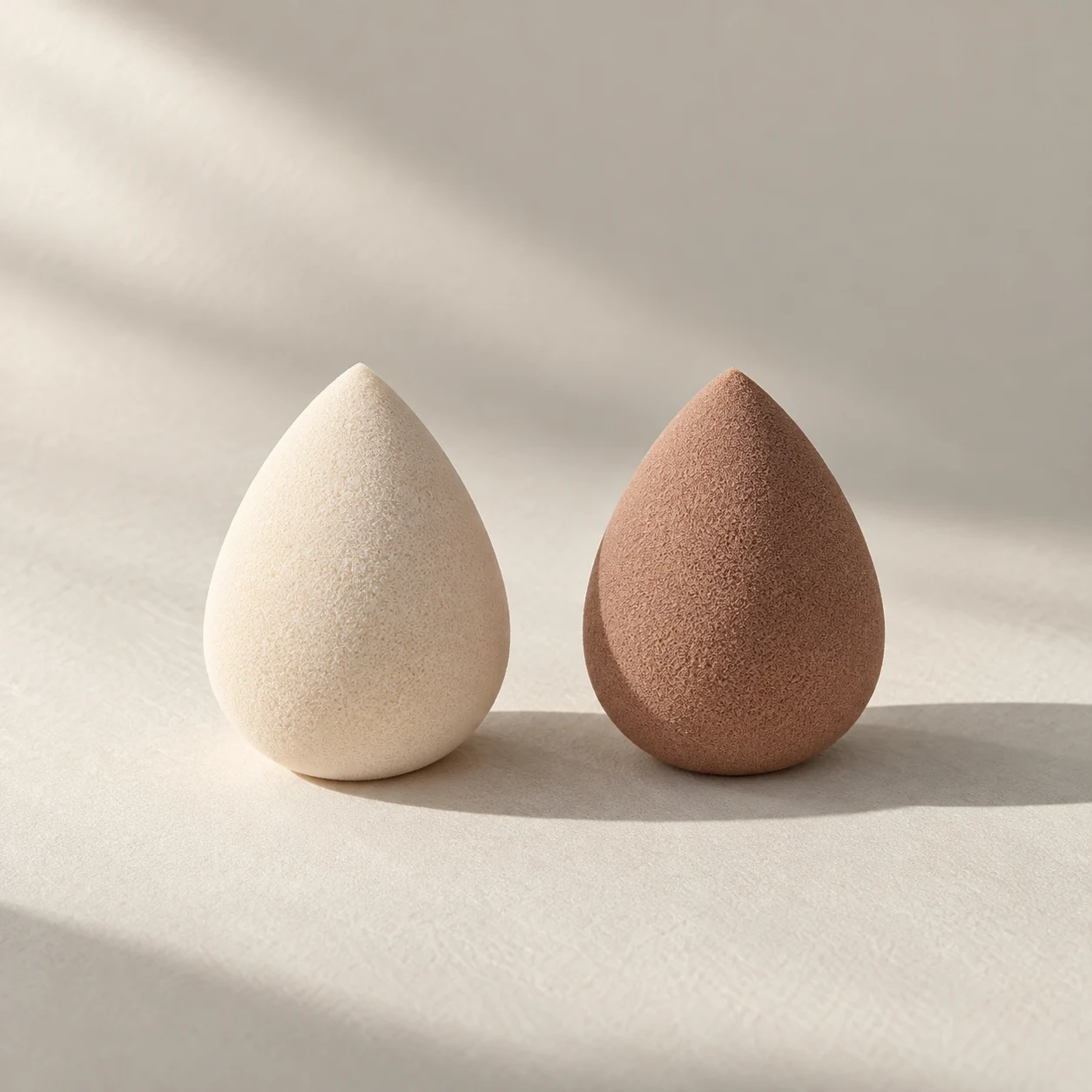 Form 04 — The Mini Pair — Two mini pointed sponges, each 30 mm high.